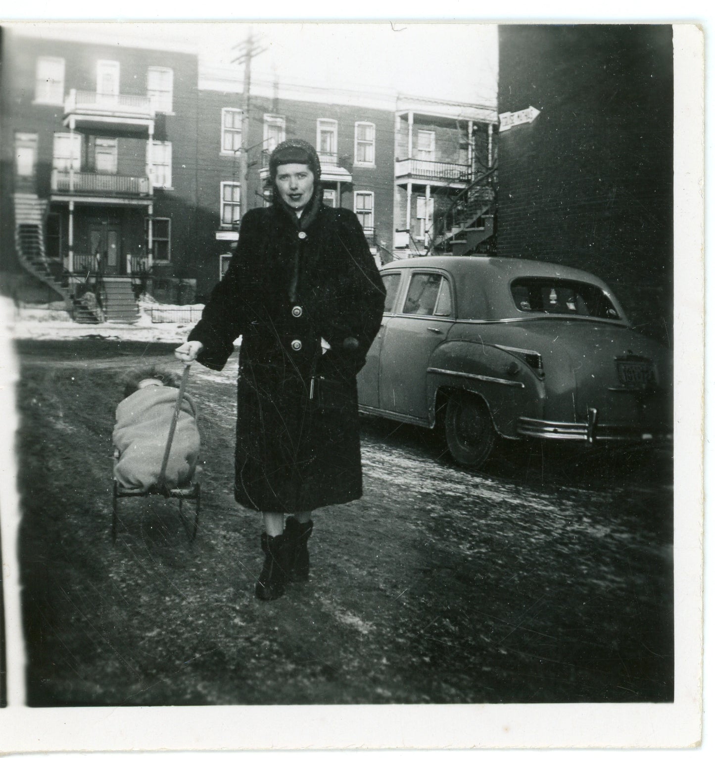 Femme avec poupon sur un traineau