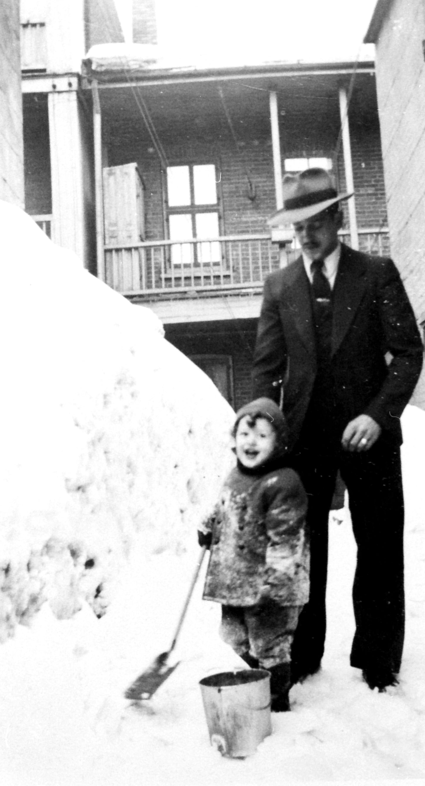 Enfant jouant dans la neige avec une pelle